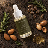 Huile de romarin CAMENYS entourée de ses ingrédients : romarin, graines de ricin, amandes et argan